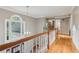 Bright hallway featuring hardwood floors, large window, and decorative lighting at 422 Laurian Nw Way, Kennesaw, GA 30144