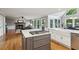 Gourmet kitchen with gray island, stone fireplace in living room, and stainless steel appliances at 422 Laurian Nw Way, Kennesaw, GA 30144