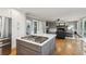 Modern kitchen featuring stainless steel appliances, gray island, and hardwood floors at 422 Laurian Nw Way, Kennesaw, GA 30144