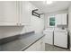 Functional laundry room with ample counter space, cabinets, and modern washer and dryer at 422 Laurian Nw Way, Kennesaw, GA 30144