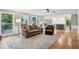 Open-concept living room with hardwood floors, a cozy fireplace, and access to the kitchen at 422 Laurian Nw Way, Kennesaw, GA 30144