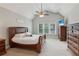 Spacious primary bedroom with vaulted ceiling, fan, and a suite of dark wood furniture at 422 Laurian Nw Way, Kennesaw, GA 30144