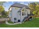 Rear exterior showcasing a deck, patio, manicured lawn, and tasteful landscaping at 422 Laurian Nw Way, Kennesaw, GA 30144