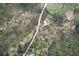 Vast aerial view featuring a long gravel driveway leading to a home surrounded by dense forest and natural landscape at 7746 Tyree Rd, Winston, GA 30187