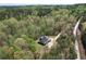 Captivating aerial shot of a home nestled among dense trees, featuring a long driveway leading to a private residence at 7746 Tyree Rd, Winston, GA 30187