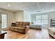 Finished basement area with hardwood floors, a brown sofa, daybed, and a door to the backyard at 7746 Tyree Rd, Winston, GA 30187