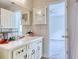 Bright bathroom featuring double vanity, mirrored cabinet, and doorway to the bedroom at 7746 Tyree Rd, Winston, GA 30187