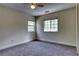 Carpeted bedroom with two windows, ceiling fan, and neutral color palette at 7746 Tyree Rd, Winston, GA 30187