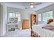 Bright bedroom with a desk, bed, dresser, and carpeted flooring at 7746 Tyree Rd, Winston, GA 30187