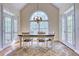 Bright dining room with large windows and doors, wooden table, and rug at 7746 Tyree Rd, Winston, GA 30187