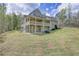 Back of home with tiered deck overlooking the landscaped yard and forest at 7746 Tyree Rd, Winston, GA 30187