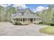 Charming two-story home with a sprawling front porch and a well-manicured lawn at 7746 Tyree Rd, Winston, GA 30187