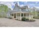 Inviting two-story house boasts a wide front porch perfect for relaxation and enjoying nature at 7746 Tyree Rd, Winston, GA 30187