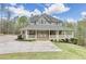 Charming two-story home with a sprawling front porch and a well-manicured lawn at 7746 Tyree Rd, Winston, GA 30187