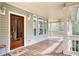 Welcoming front porch featuring a wood deck and a stained glass front door at 7746 Tyree Rd, Winston, GA 30187