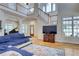 Open-concept living room boasts high ceilings, hardwood floors, fireplace, and plenty of natural light at 7746 Tyree Rd, Winston, GA 30187