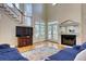 This gorgeous living room boasts a fireplace and gleaming wood floors at 7746 Tyree Rd, Winston, GA 30187