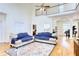 Bright living room features hardwood floors, a soaring ceiling, and an open balcony at 7746 Tyree Rd, Winston, GA 30187