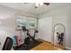 Bedroom featuring an exercise bike, hardwood floors, closet, and plenty of natural light at 2419 Little John Se Trl, Marietta, GA 30067