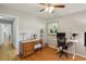 Bright bedroom with desk, chair, and dresser offers hardwood floors and natural light at 2419 Little John Se Trl, Marietta, GA 30067