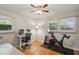 This bedroom has two windows, hardwood floors, a desk and chair, and exercise equipment at 2419 Little John Se Trl, Marietta, GA 30067