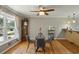 Charming dining area featuring hardwood floors, a glass table with seating, and an adjacent kitchen at 2419 Little John Se Trl, Marietta, GA 30067