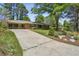 Inviting brick home with an extended driveway and charming landscaping, offering great curb appeal at 2419 Little John Se Trl, Marietta, GA 30067
