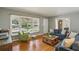 Open living space with hardwood floors, a large window, and comfortable seating creating an inviting atmosphere at 2419 Little John Se Trl, Marietta, GA 30067