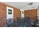 Brick patio offers a table with chairs, overhead lighting, and access to the back yard at 2419 Little John Se Trl, Marietta, GA 30067