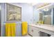 Bathroom with large window, full-sized mirror, sink, white vanity, and bright yellow towels at 30 Dogwood Trl, Dallas, GA 30157
