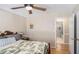 Comfortable bedroom with light walls, a ceiling fan and an open doorway to the en-suite bathroom at 30 Dogwood Trl, Dallas, GA 30157