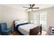Cozy bedroom featuring a ceiling fan, large window, and comfortable furnishings at 30 Dogwood Trl, Dallas, GA 30157
