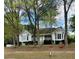 Charming white home featuring well-maintained landscaping and a welcoming covered front porch at 30 Dogwood Trl, Dallas, GA 30157