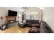 Comfortable living room features a fireplace, vaulted ceiling, large sofa and hardwood floors at 30 Dogwood Trl, Dallas, GA 30157