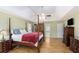 This spacious primary bedroom features a trey ceiling, ceiling fan, hardwood floors, and ensuite bath at 30 Dogwood Trl, Dallas, GA 30157