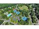 Panoramic aerial view of the community featuring the swimming pool, tennis courts, playground, and green spaces at 3230 Riverhill Ct, Cumming, GA 30041