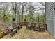 Backyard deck with flagstone flooring, chairs, and outdoor space at 3230 Riverhill Ct, Cumming, GA 30041