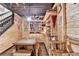Basement with wood walls, shelves, a table and bench with stairs in background at 3230 Riverhill Ct, Cumming, GA 30041