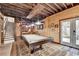 Basement entertaining space features a pool table, bar and exposed wood ceiling at 3230 Riverhill Ct, Cumming, GA 30041