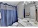 Clean bathroom featuring a vanity, mirror, a shower with blue curtain, and a toilet at 3230 Riverhill Ct, Cumming, GA 30041