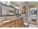 Elegant bathroom with double vanity, tile accents, and walk-in closet access at 3230 Riverhill Ct, Cumming, GA 30041