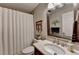 Well-lit bathroom with a vanity, framed mirror, and shower with white shower curtain at 3230 Riverhill Ct, Cumming, GA 30041