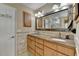 Stylish bathroom with dual sinks, framed mirror, and convenient storage cabinet at 3230 Riverhill Ct, Cumming, GA 30041