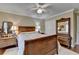 Comfortable bedroom with wooden bed frame, hardwood floors, ceiling fan and natural light from the window at 3230 Riverhill Ct, Cumming, GA 30041
