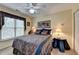 Charming bedroom featuring a window with patterned curtains, ceiling fan, and comfortable bed at 3230 Riverhill Ct, Cumming, GA 30041