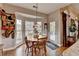 Charming breakfast nook with bay windows, a stained glass pendant lamp, and access to the outdoor deck at 3230 Riverhill Ct, Cumming, GA 30041