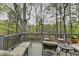 Relaxing deck area with ample seating and beautiful wooded views, perfect for outdoor entertaining at 3230 Riverhill Ct, Cumming, GA 30041