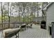 Outdoor deck with patio furniture and scenic views of surrounding trees at 3230 Riverhill Ct, Cumming, GA 30041