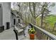 Inviting deck featuring comfortable seating, a potted plant, and tranquil views of the surrounding nature at 3230 Riverhill Ct, Cumming, GA 30041