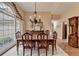 Formal dining room with large window, chandelier and ample space for entertaining at 3230 Riverhill Ct, Cumming, GA 30041